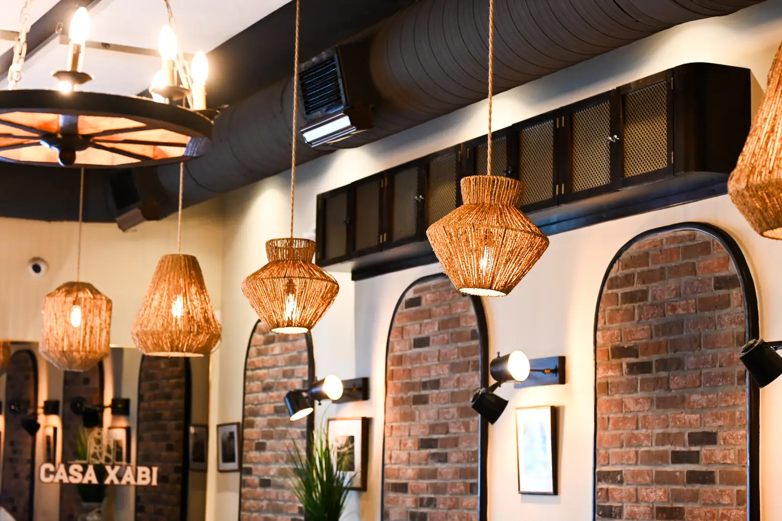 Woven pendant lamps above the dining room